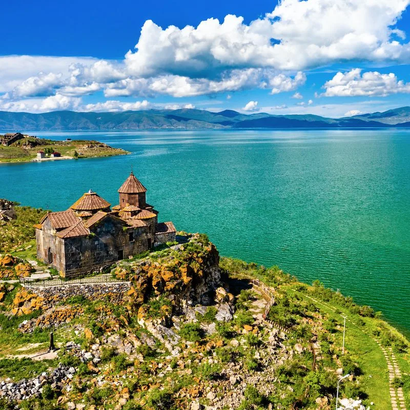 Aerial View Of An Armenian Church On The Shores Of A Lake In Armenia, Caucasus Region Between Western Asia And Eastern Europe