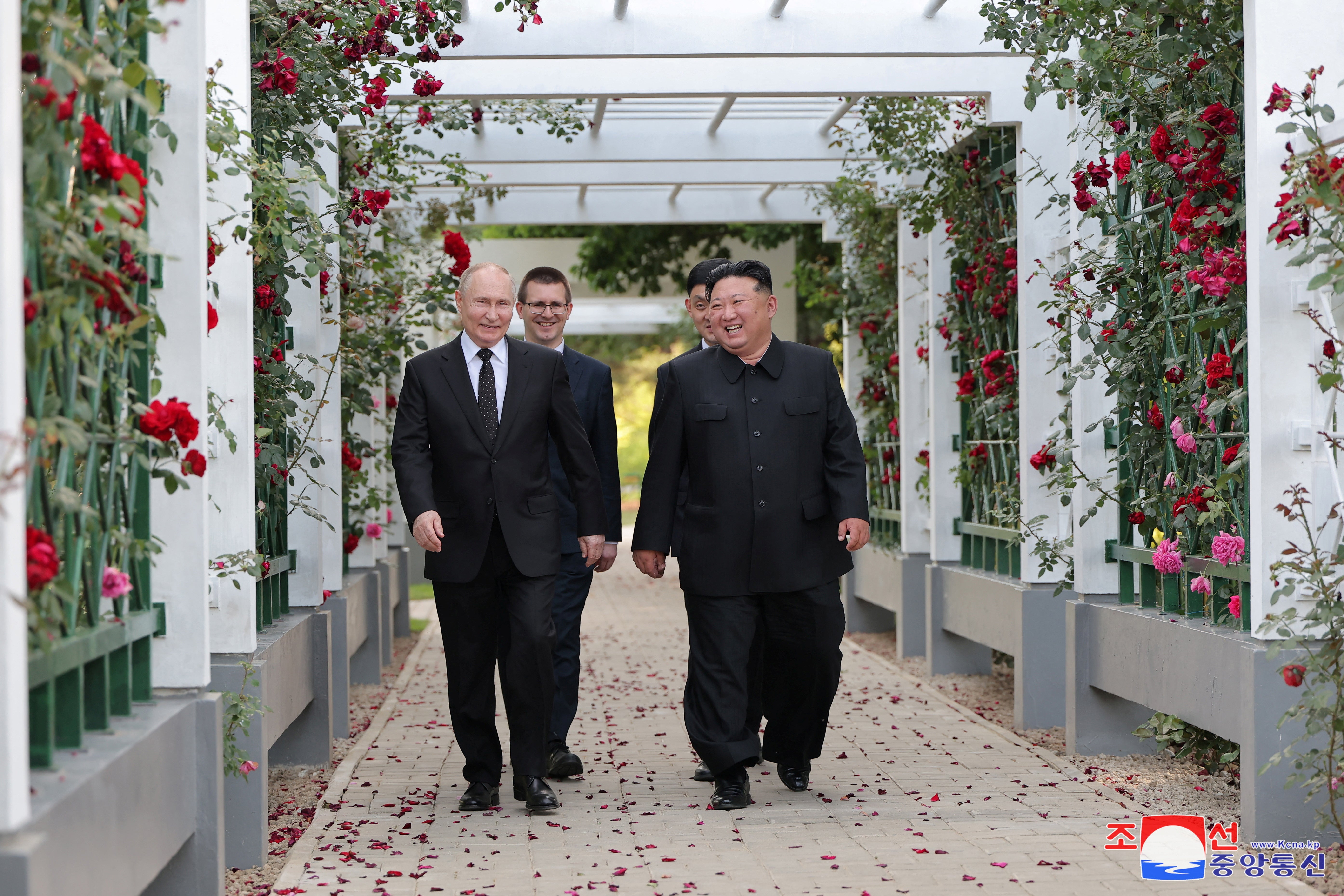 Russia’s president Vladimir Putin and North Korea’s leader Kim Jong-un react during a walk in the garden of the Kumsusan Guesthouse in Pyongyang