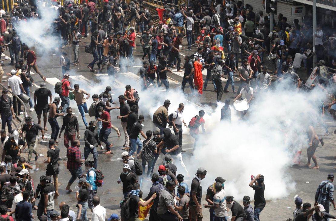 Demonstrators run from tear gas used by police during a protest demanding the resignation of President Gotabaya Rajapaksa near the president's residence in Colombo, Sri Lanka, on Saturday.