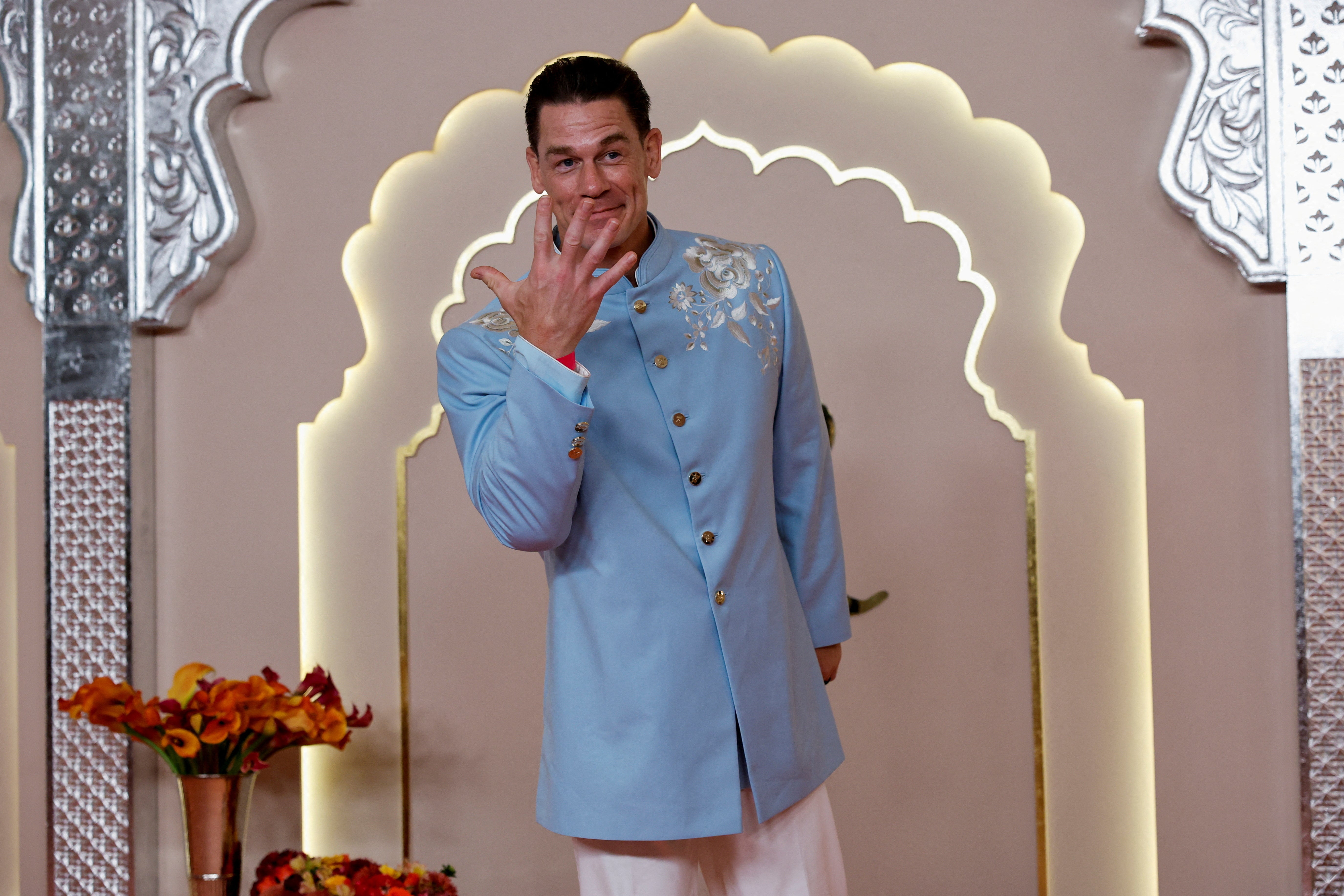 John Cena poses for pictures on the red carpet on the day of the wedding of Anant Ambani and Radhika Merchant