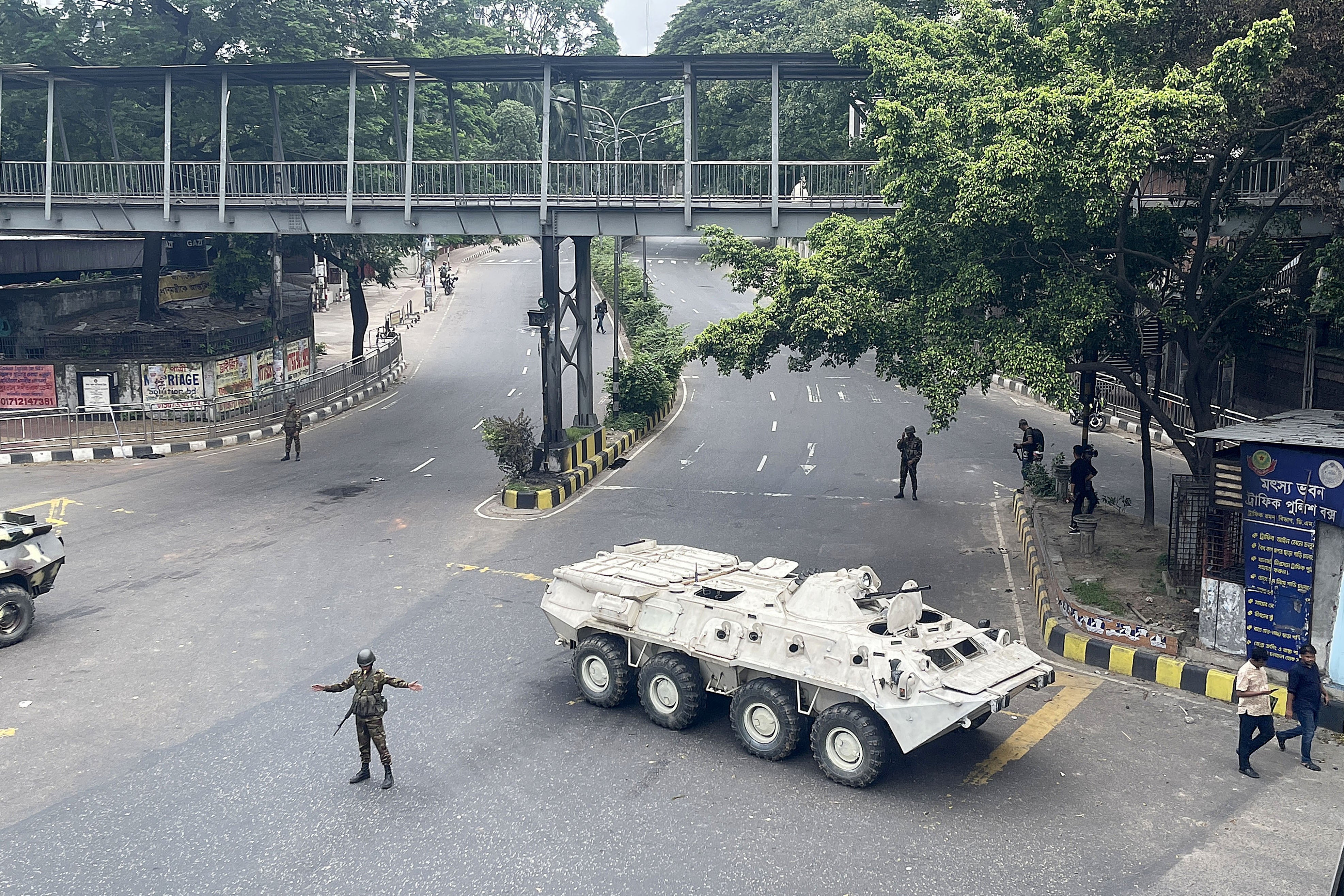 Bangladeshi soldiers stand guard on a street during curfew in Dhaka, Bangladesh