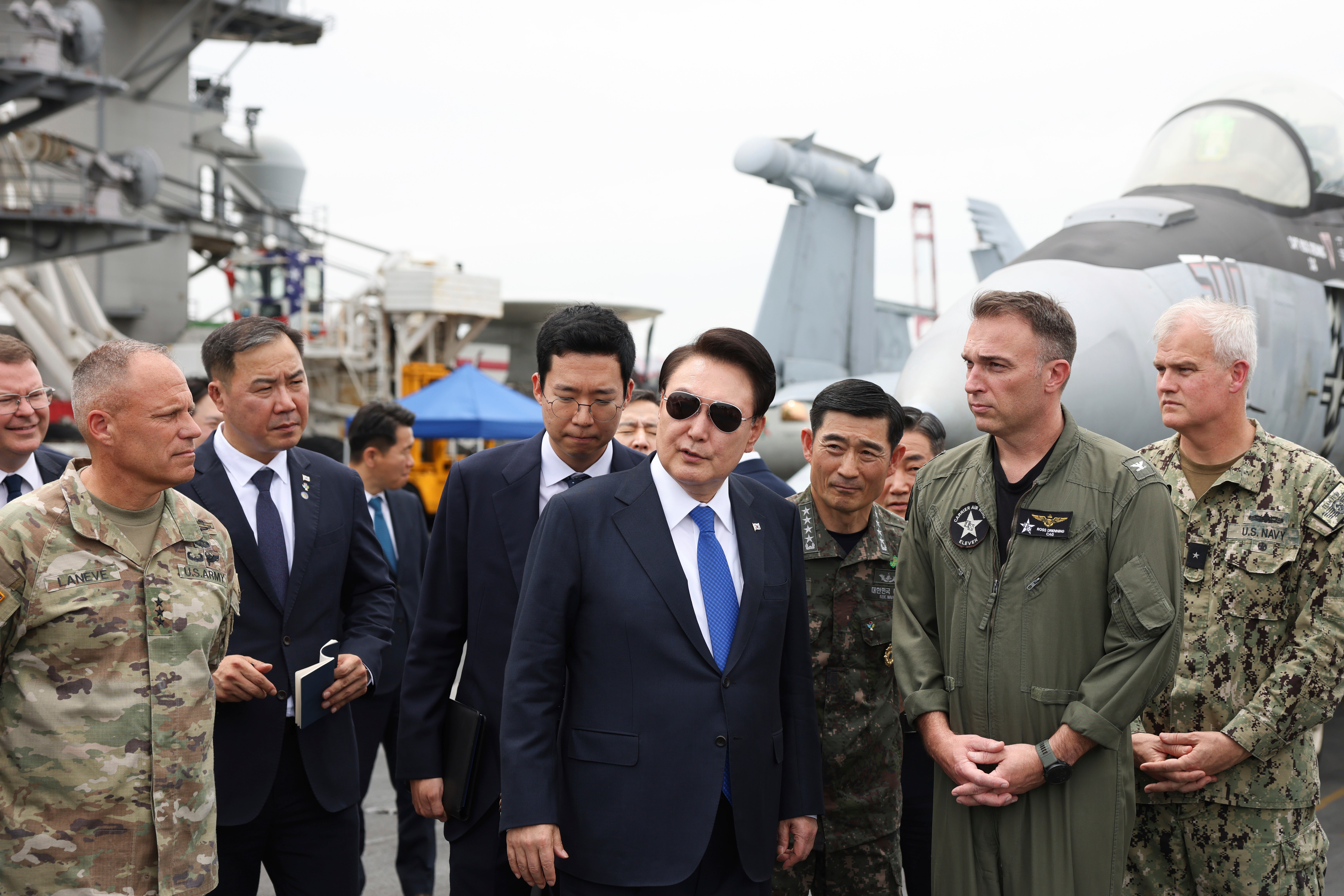 Yoon Suk Yeol boards the USS Theodore Roosevelt aircraft carrier at the South Korean naval base in Busan on 25 June 2024