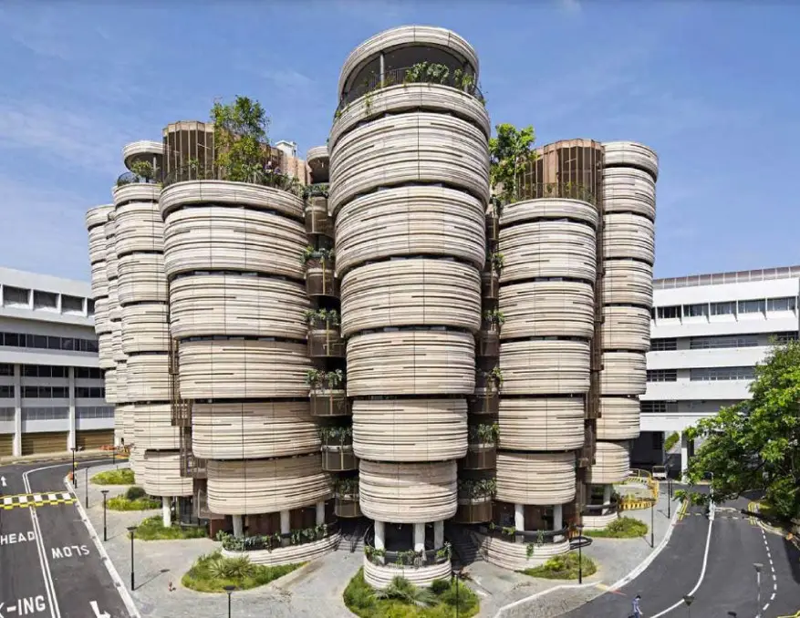 Exterior view of The Hive at Nanyang Technological University in Singapore, featuring its unique beehive-like structure with multiple cylindrical towers.