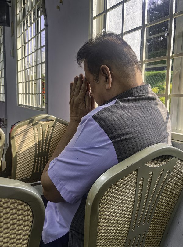 Vikraman, who preaches for the Tamil and English services of the Seremban Church of Christ, prays at the beginning of the Respite retreat.