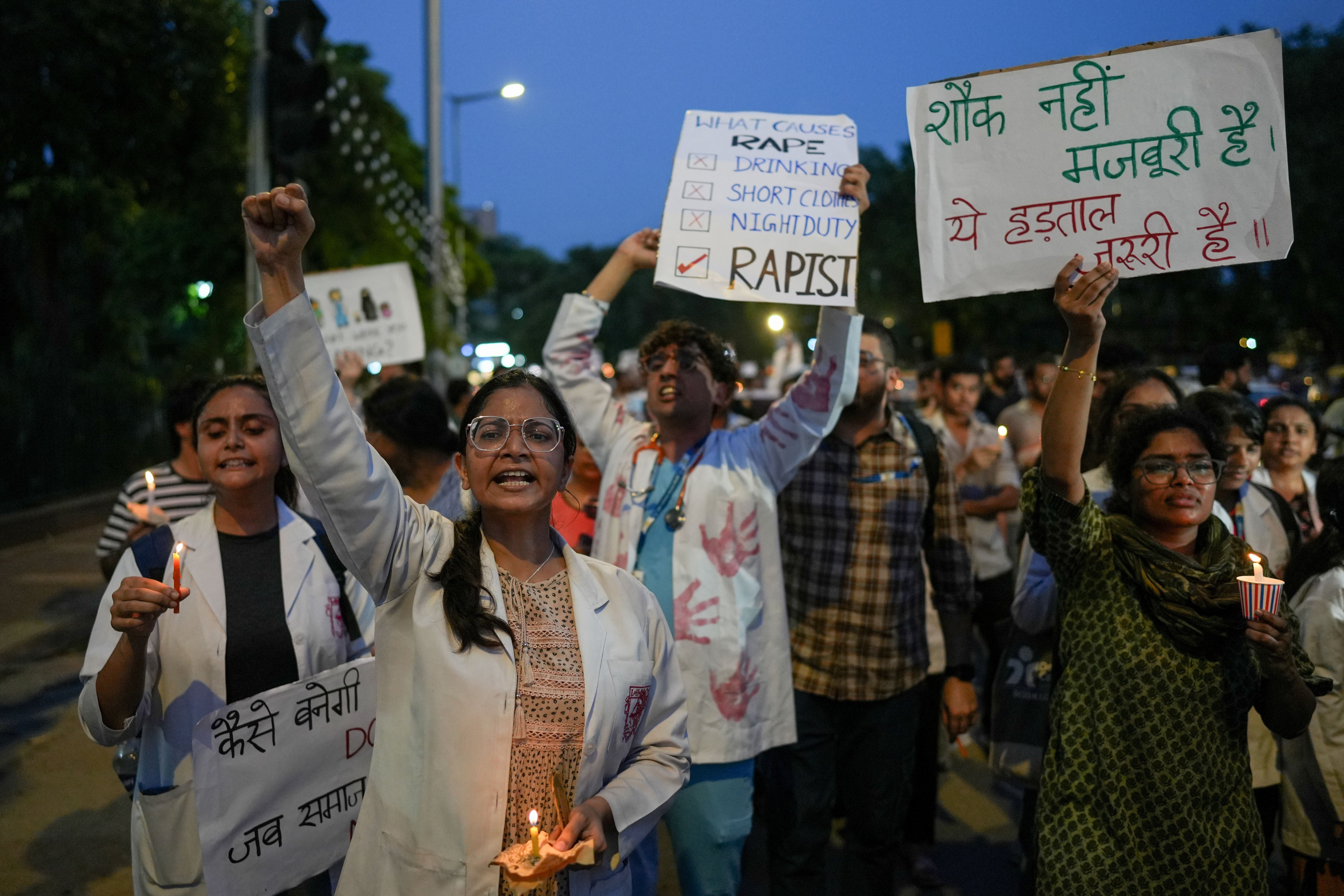 Doctors light candles during a protest in Delhi