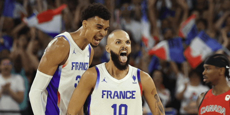 Victor Wembanyama #32 and Evan Fournier #10 of Team France celebrate making the Basketball Semi Finals at Olympics 2024