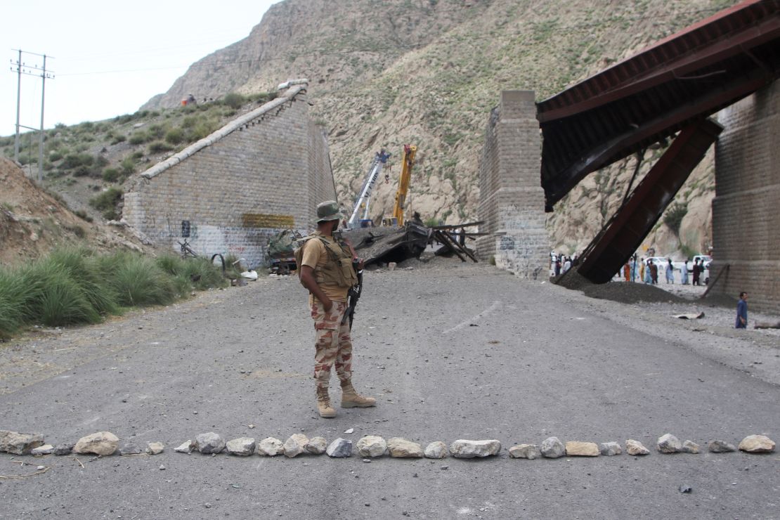 A paramilitary soldier stands on a road, as restoration works go on at damaged railway tracks, a day after separatist militants conducted deadly attacks, in Bolan district of Pakistan's restive province of Balochistan, Pakistan, August 27, 2024. REUTERS/Naseer Ahmed