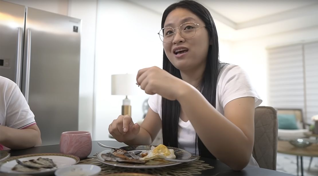 Guo eats fried dried fish, a typical Filipino dish in a video posted to Youtube on April 20, 2022.