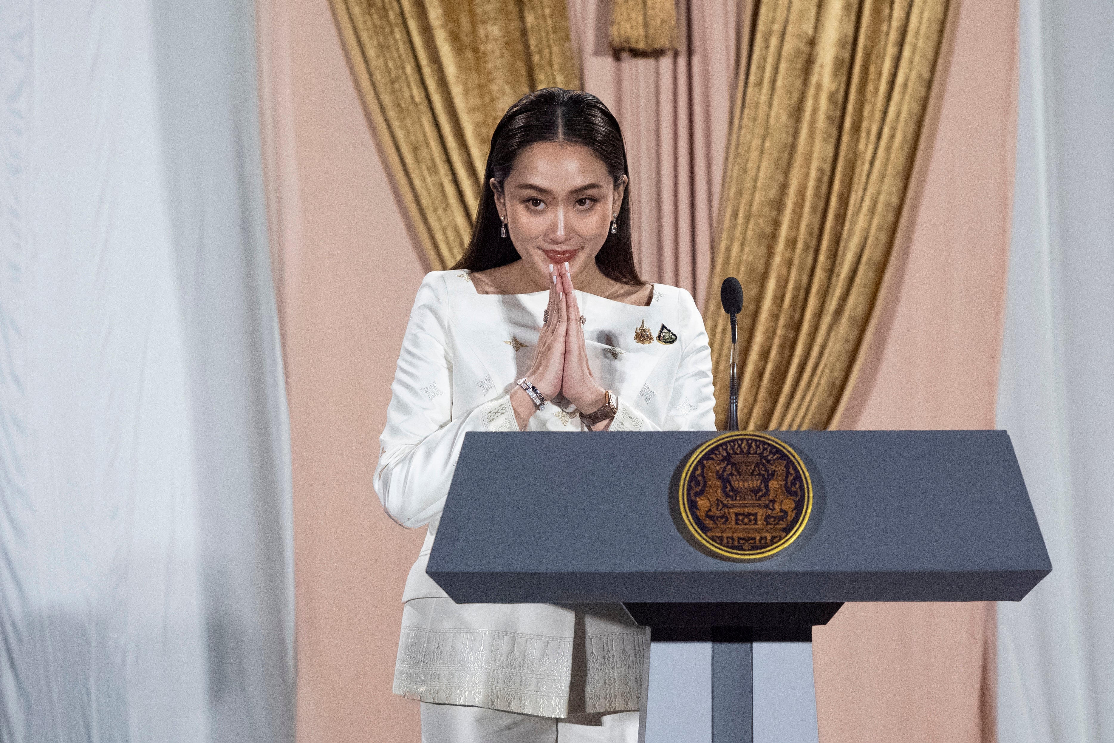 Paetongtarn Shinawatra greets members of the media during a press conference after the royal endorsement ceremony appointing her as the new prime minister of Thailand, in Bangkok on August 18, 2024