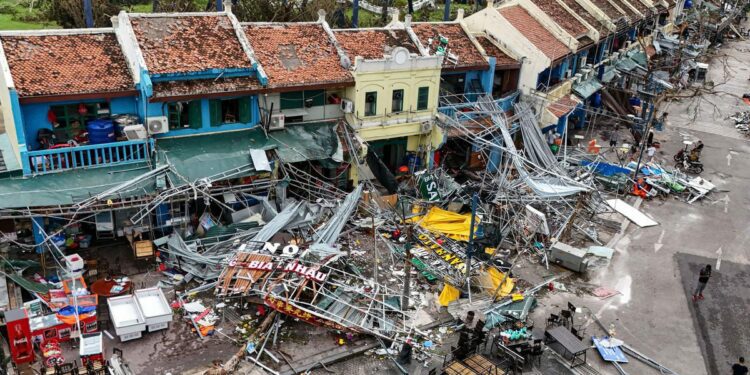 Typhoon Yagi hits Vietnam with torrential rains, killing almost 60 as vehicles and a bridge are swept away