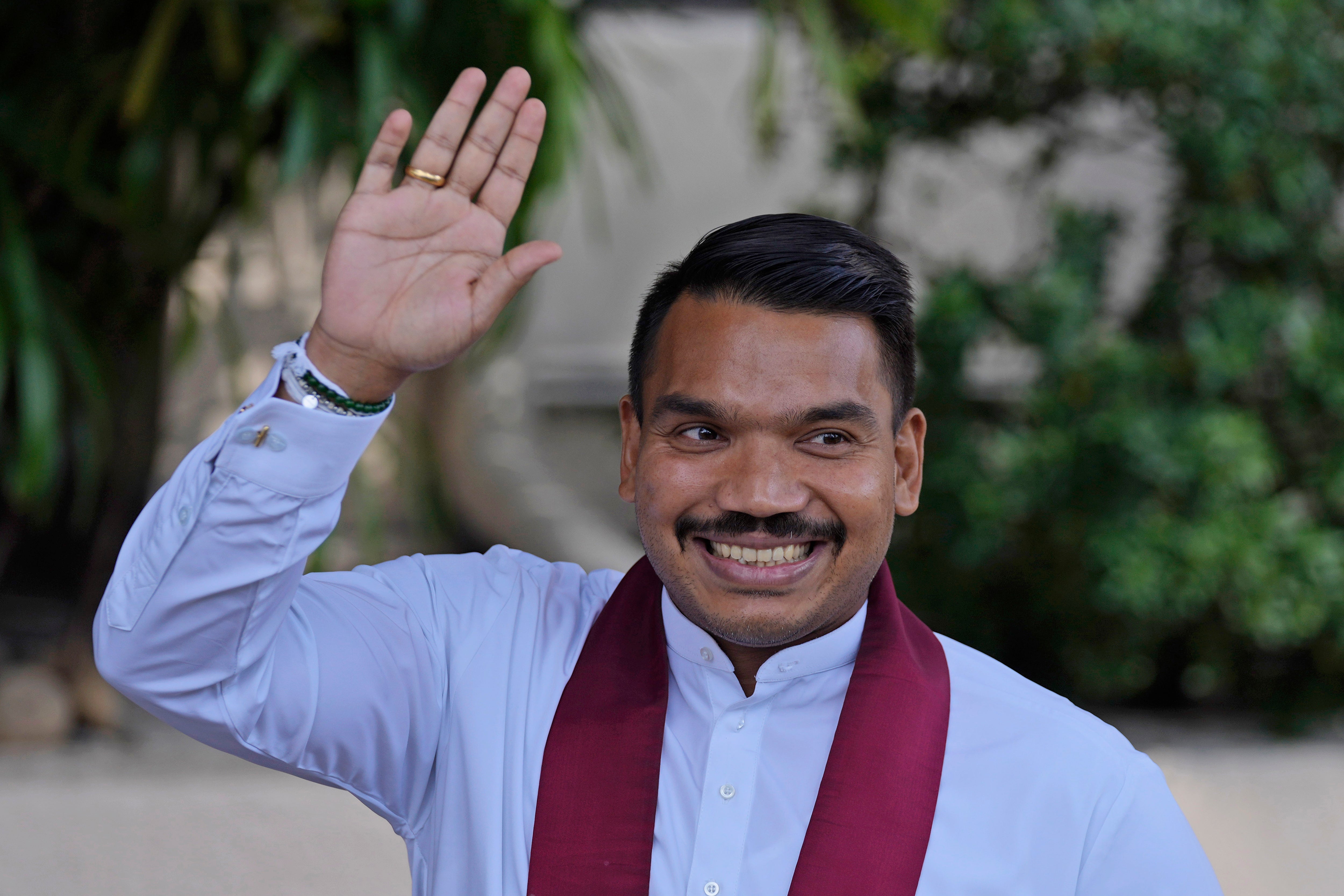 Namal Rajapaksa, son of former President Mahinda Rajapaksa waves to media as he arrives to file nomination for the upcoming presidential election in Colombo, Sri Lanka